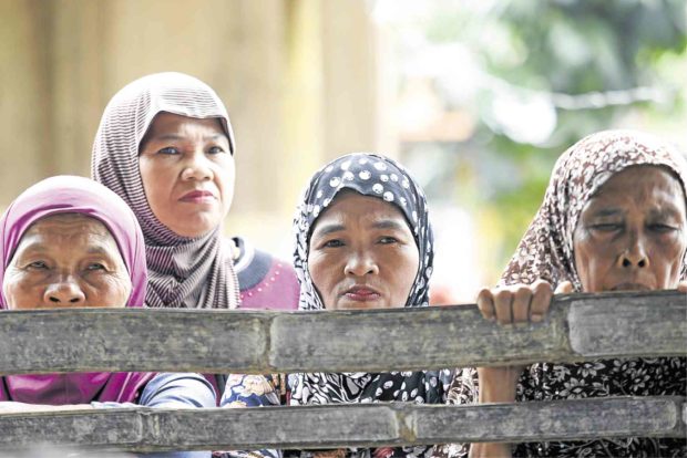 Maranao women in the village of Sagunsong in Marawi City wait for news about plans to build a tent city for those displaced by the war between government and terrorists, which is wrecking the economy of nearby areas, like the town of Balo-i in Lanao del Norte province. —JEOFFREY MAITEM