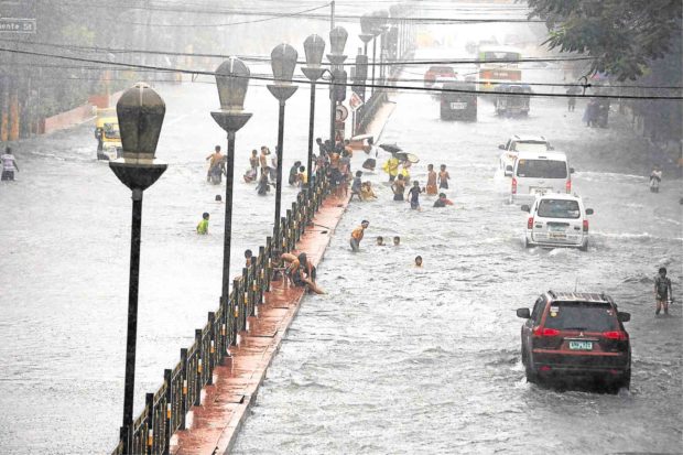 UNDERWATER  One of Manila’s main thoroughfares, España, is submerged by floods brought by Tropical Depression “Maring.” At least five people were reported dead and six missing.—JOAN BONDOC