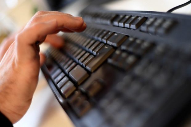 PHOTO: Stock image of hands typing on computer keyboard. STORY: China offers to help hunt website hackers, says DICT