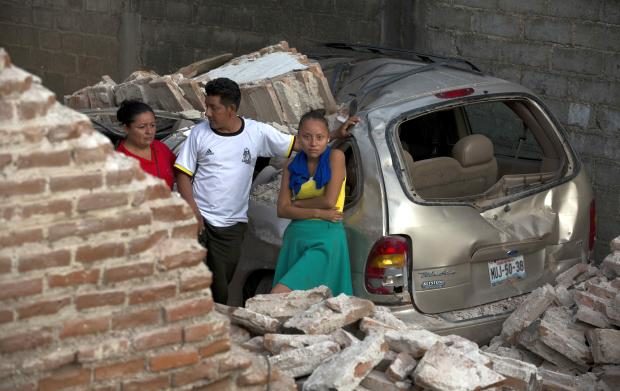 Family in rubble of home in Juchitan in Mexico - 9 Sept 2017