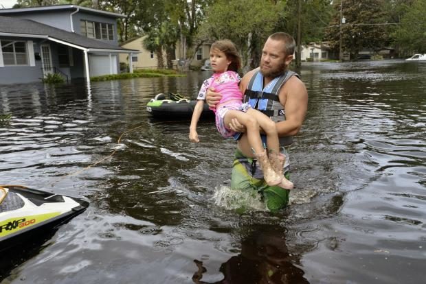 Man carries child in flood - Jacksonville in Florida - 11 Sept 2017
