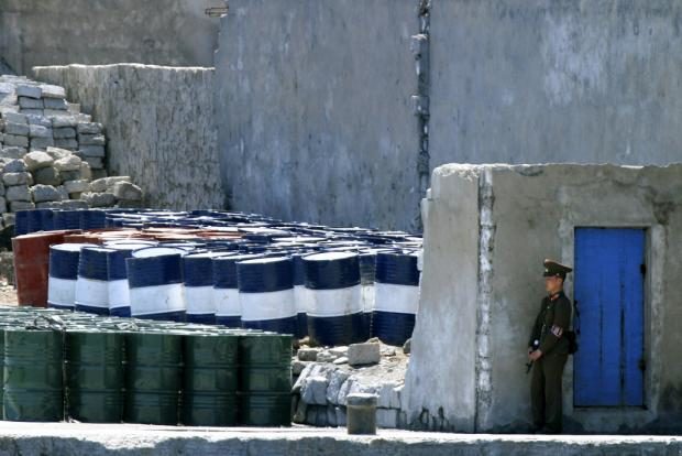 North Korean soldier guarding oil barrels - 8 May 2016