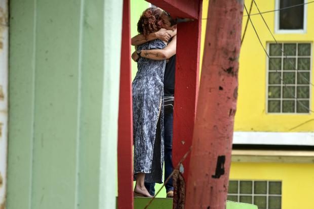 Puerto Rican couple embrace - 25 Sept 2017
