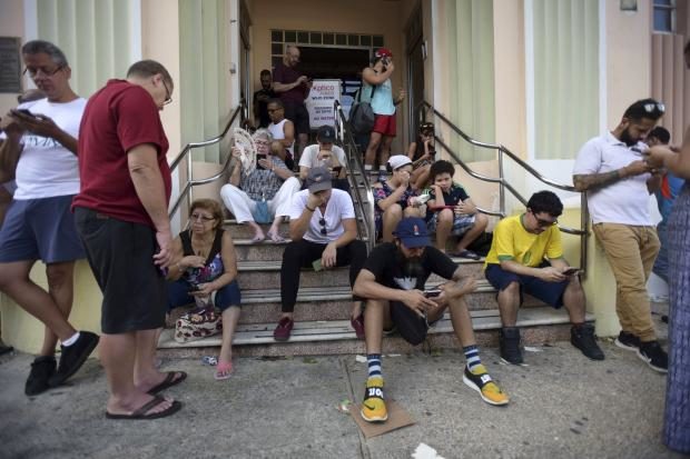 Puerto Ricans gather at wi-fi hotspot - 24 Sept 2017