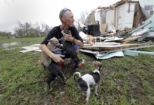 Sam Speights with dogs in front of home wreckage - 27 Aug 2017