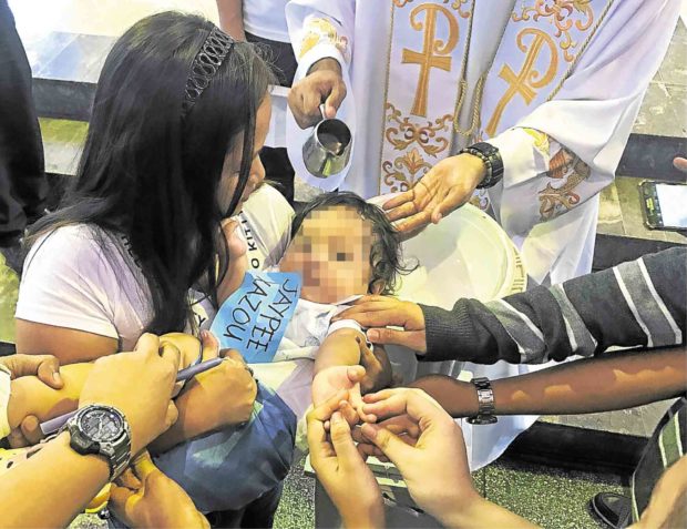 Double celebration: Jaypee Bertes Jr.’s christening day was also his first birthday. —JHESSET O. ENANO 