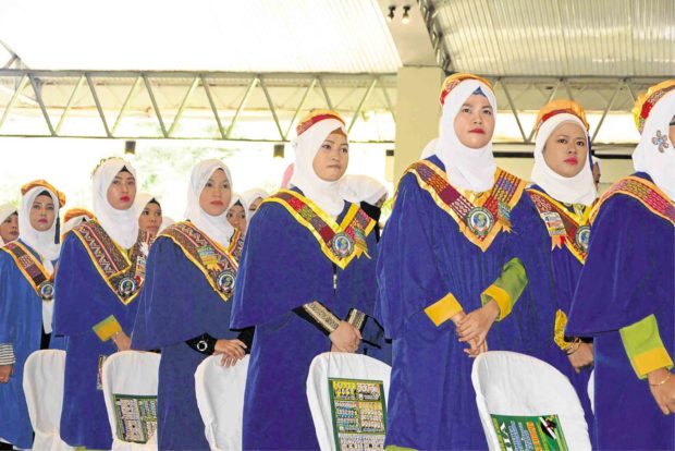 Some of the students of Khadijah Mohammad Islamic Academy in Marawi City, who attended a graduation ceremony three months late in Iligan City, were able to bring their toga with them. —DIVINA M. SUSON