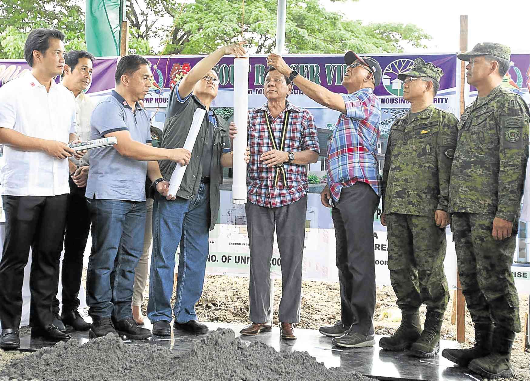 President Duterte, accompanied by defense and housing officials, leads the groundbreaking ceremony for a housing project for soldiers in San Miguel town, Bulacan province.  —JOAN BONDOC