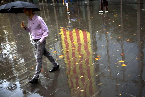People walking on reflection of Catalan flag - 19 October 2017