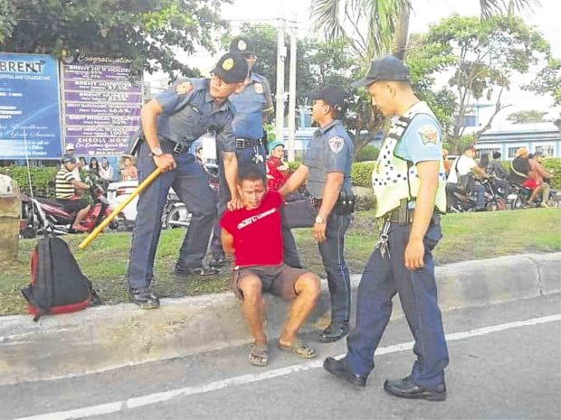 The last time Eduardo Serino Sr. was seen alive was with these policemen accosting him on RT Lim Boulevard on Sept. 30. Eduardo would be dead, technically in police custody, about two hours after this photo was taken. —CONTRIBUTED PHOTO