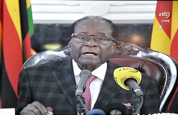 This photograph taken on November 19, 2017, shows a television broadcasting Zimbabwe's President Robert Mugabe delivering a speech in Harare, following a meeting with army chiefs who have seized power in Zimbabwe. Zimbabwean President Robert Mugabe, in a much-expected TV address, stressed he was still in power after his authoritarian 37-year reign was rocked by a military takeover. Many Zimbabweans expected Mugabe to resign after the army seized power last week. But Mugabe delivered his speech alongside the uniformed generals who were behind the military intervention. In his address, Mugabe made no reference to the clamour for him to resign.   / AFP PHOTO / STR