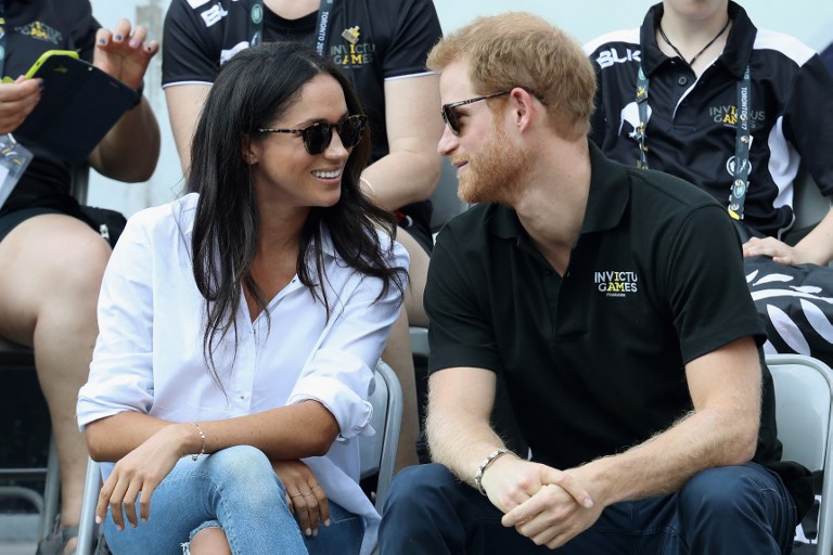 (FILES) This file photo taken on September 25, 2017 shows Britain's Prince Harry (R) and Meghan Markle (L) attend a Wheelchair Tennis match during the Invictus Games 2017 at Nathan Philips Square on September 25, 2017 in Toronto, Canada. Britain's Prince Harry will marry his US actress girlfriend Meghan Markle early next year after the couple became engaged earlier this month, Clarence House announced on November 27, 2017. / AFP PHOTO / GETTY IMAGES NORTH AMERICA / CHRIS JACKSON