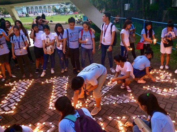 Students light candles in Bicol University in commemoration of the Maguindanao massacre Wednesday night. Photo by Ma. April Mier, Inquirer Southern Luzon