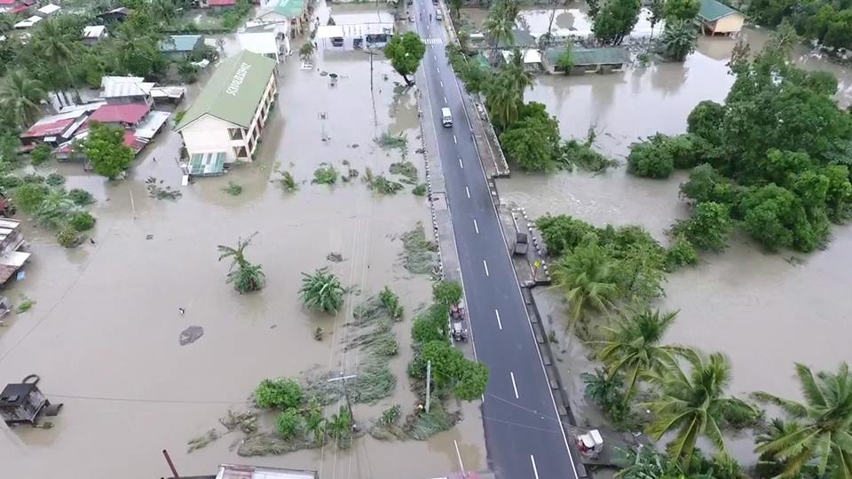 An aerial photo of the Buacayao river area shows flood slowly engulfing Strong Republic Nautical Highway in Calapan City as Tropical Storms "Urduja" and "Vinta" bring days of rain in South Luzon. Photos by Aristedes Leuterio of Oriental Mindoro PDRRMO