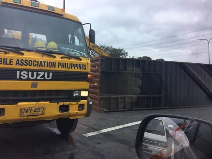 A truck fell sideways after figuring into an accident at Southbound lane of the South Luzon Expressway (SLEX). Photo by Ju Li, Contributor