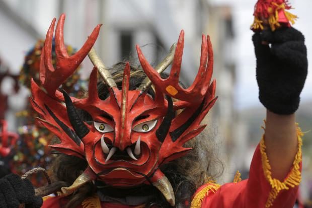 Man wearing devil mask in Ecuador - 7 Jan 2018