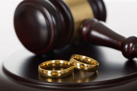 Closeup wedding rings with gavel. STORY: SC rules in favor of woman who called off wedding