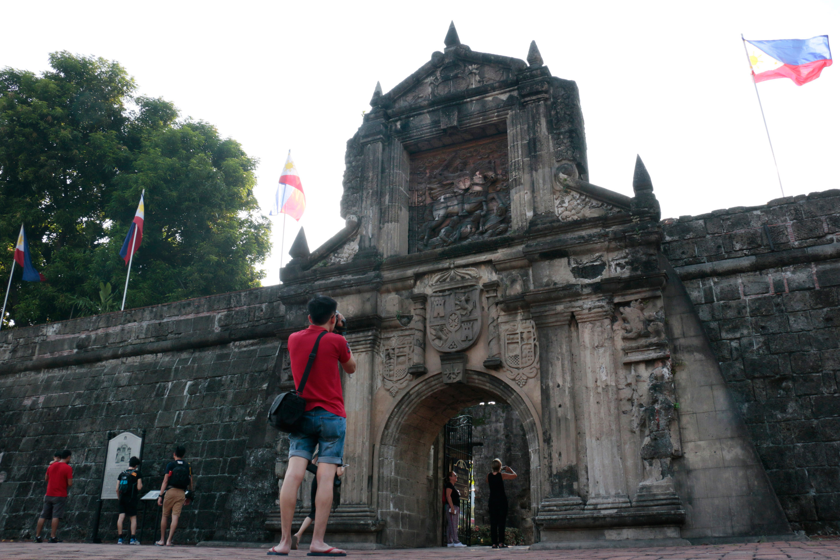 A tourist takes a photo at Fort Santiago in Manila on June 16, 2017. Philippines has fired one of the world's top advertising firms in a row over alleged plagiarism, adding more misery to its tourism industry already reeling from a war with Islamist militants and a deadly crackdown on drugs. The tourism department on June 16 cancelled its contract with McCann Worldgroup Philippines and demanded an apology, after deeming its just-launched promotion for the Southeast Asian nation was too similar to a 2014 South African campaign. / AFP PHOTO / JOSEPH AGCAOILI