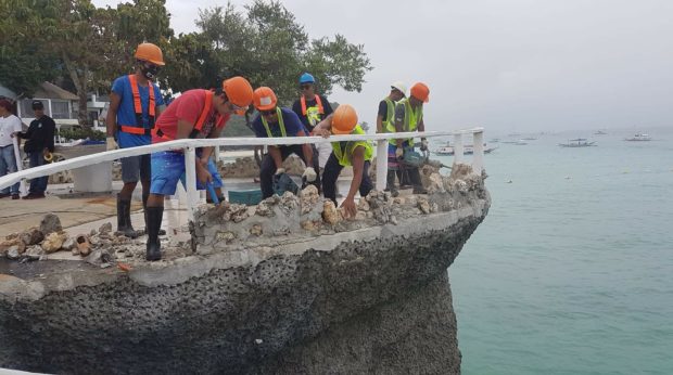 Workers tear concrete structures built on top of rock formations at the Boracay Westcove resort (By Nestor P. Burgos Jr.)