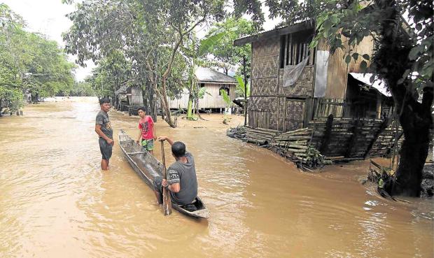 Residents in boat in flood Agusan del Norte - 13 Feb 2018
