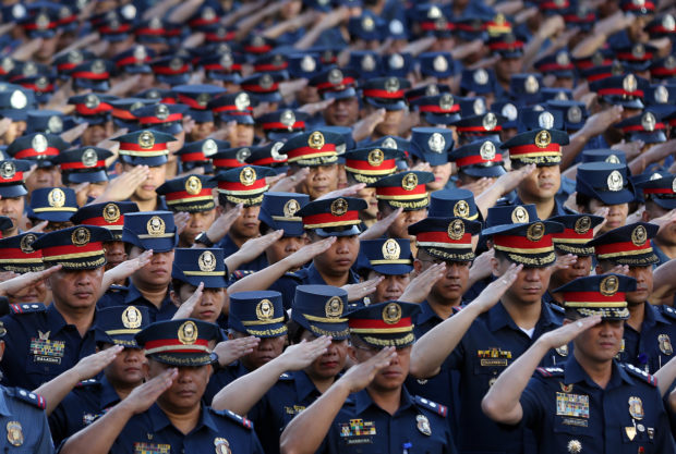 Police officers in formation saluting. STORY: PNP gets 12 more generals
