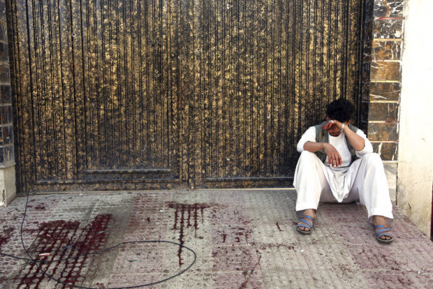 A relative of a victim cries outside a voter registration center which was attacked by a suicide bomber in Kabul, Afghanistan, Sunday, April 22, 2018. Gen. Daud Amin, the Kabul police chief, said the suicide bomber targeted civilians who had gathered to receive national identification cards. (AP Photo/ Rahmat Gul)