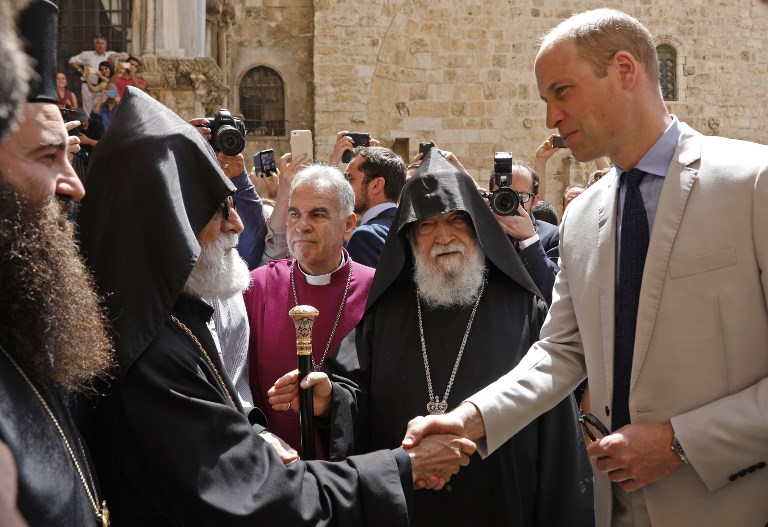 Britain's Prince William shakes hand to Armenian clergy as he arrives to the Church of the Holy Sepulchre on June 28, 2018 in Jerusalem's Old City. The Duke of Cambridge is the first member of the royal family to make an official visit to the Jewish state and the Palestinian territories. / AFP PHOTO / GALI TIBBON