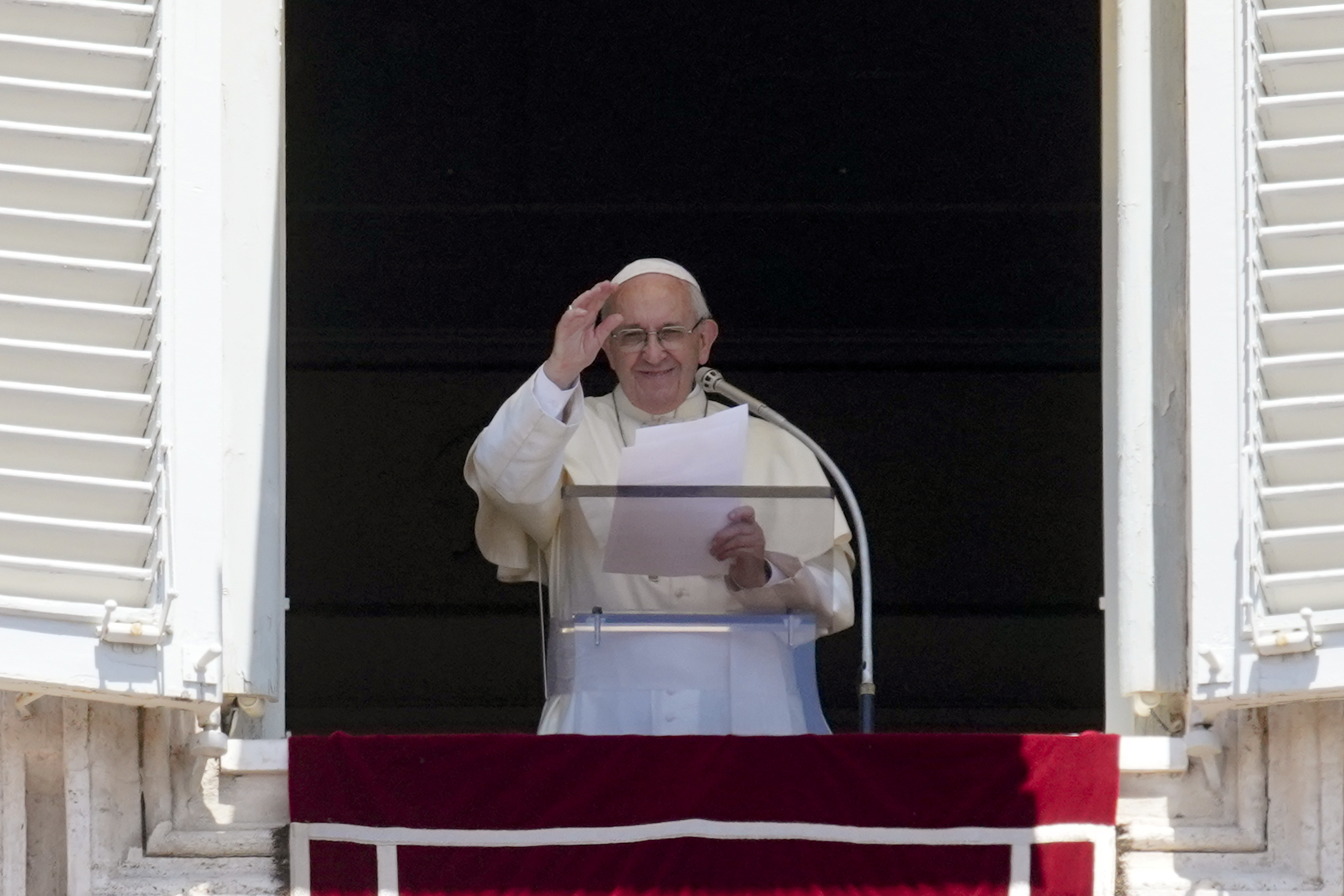 Pope Francis waves to the crowd as he recites the Angelus noon prayer from the window of his studio overlooking St. Peter's Square, at the Vatican, Sunday, June 10, 2018. (AP Photo/Andrew Medichini)