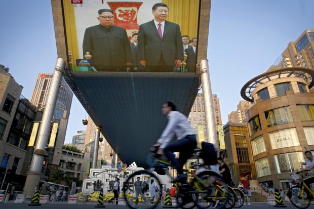 Kiim Jong-Un and Xi Jinping street TV screen