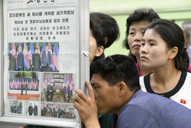 North Koreans reading news on Trump-Kim summit