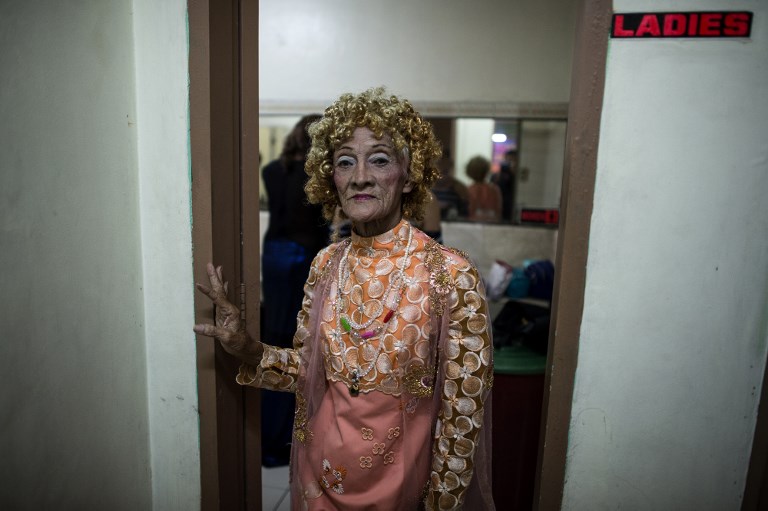 This photo taken on June 16, 2018 shows street vendor and Golden Gays member Al Enriquez, 82, also known as "Carmen Dela Rue", posing for a photo before the start of the Golden Gays of Manila Beauty Pageant at a restaurant in Manila. The Philippines has a reputation of openness toward homosexuality, but experts say legal protections are lacking and the nation's weak social safety net especially fails older gay people. That's why the Golden Gays have recruited corporate and private sponsors who pay for their members to get a decent lunch and a few days' worth of groceries after the pageants they hold at least once a month. / AFP PHOTO / NOEL CELIS / TO GO WITH Philippines-homosexuality-poverty-charity,FEATURE by Joshua Melvin