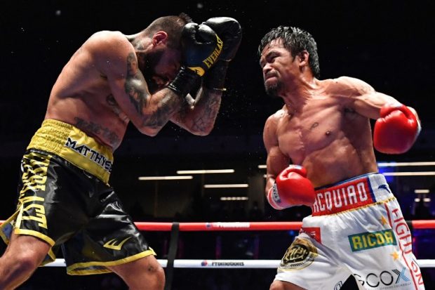 Philippines' Manny Pacquiao (R) fights Argentina's Lucas Matthysse during their world welterweight boxing championship bout at Axiata Arena in Kuala Lumpur on July 15, 2018. / AFP PHOTO / Mohd RASFAN