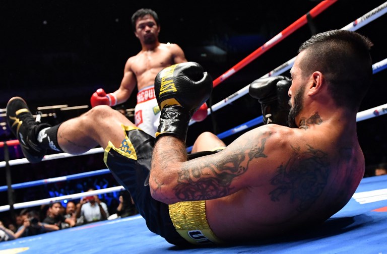 Argentina's Lucas Matthysse reacts after he was knocked down by Philippines' Manny Pacquiao during their world welterweight boxing championship bout at Axiata Arena in Kuala Lumpur on July 15, 2018. / AFP PHOTO / Mohd RASFAN