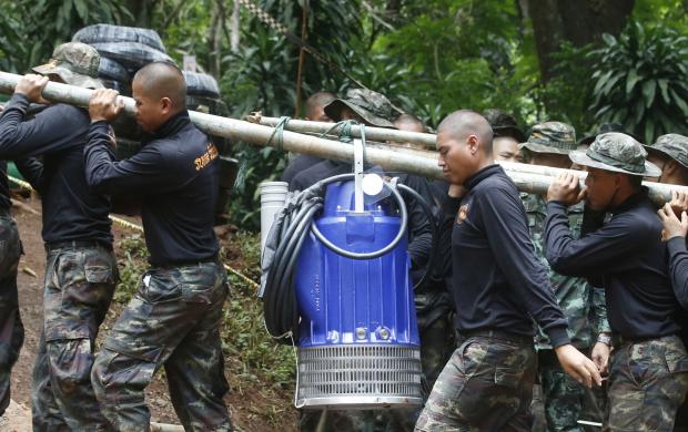 Thai soldiers carrying pump for cave rescue