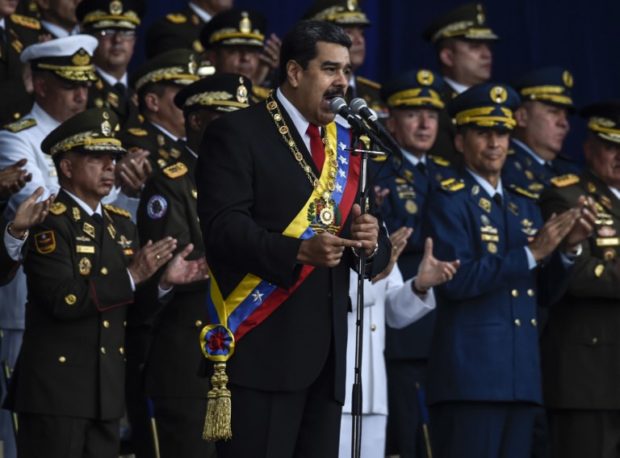 Venezuelan President Nicolas Maduro delivers a speech during a ceremony to celebrate the 81st anniversary of the National Guard in Caracas on August 4, 2018. Maduro was unharmed after an exploding drone "attack", the minister of communication Jorge Rodriguez said following the incident, which saw uniformed military members break ranks and scatter after a loud bang interrupted the leader's remarks and caused him to look to the sky, according to images broadcast on state television. / AFP PHOTO / Juan BARRETO