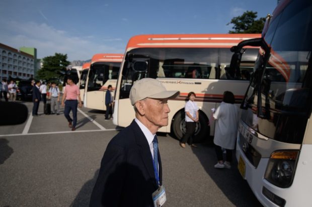 Inter-Korean family reunion participants prepare to depart for North Korea from a hotel resort in Sokcho on August 20, 2018. Dozens of elderly and frail South Koreans set off for North Korea on August 20 to meet relatives for the first time since they were separated nearly seven decades ago by a war that divided the peninsula and their families. / AFP PHOTO / Ed JONES