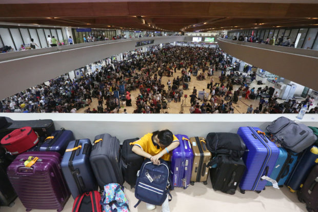 August 18 2018 NAIA- Stranded passengers wait for their flight at the NAIA Terminal 1 after chinese passenger plane Xiamen Airlines overshot it's landing before midnight on Thursday . Several flights were cancelled and diverted due to the closure of runway 06/24 until noon on Saturday. INQUIRER/ MARIANNE BERMUDEZ