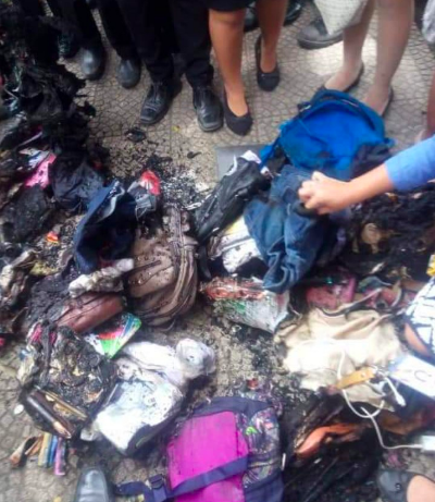 Students sift through what remained of their bags to recover clothes, cell phones or laptops after a Bicol Central Academy school official ordered them burned.—EARL VINCENT CAÑAVERAL