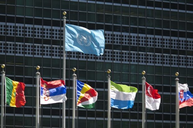 (FILES) In this file photo taken on September 24, 2015 international flags fly in front of the United Nations headquarters before the start of the 70th General Assembly meeting. North Korea and Iran will dominate this week's gathering of world leaders at the United Nations, where President Donald Trump will be in the spotlight as he continues to upend global diplomacy. After warming up to North Korean leader Kim Jong Un and ditching the Iran nuclear deal, the unpredictable Trump takes the podium on September 25, 2018 to face foes and increasingly uneasy allies at the UN General Assembly. / AFP PHOTO / DOMINICK REUTER