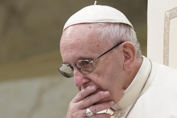 FILE - In this Aug. 22, 2018 file photo, Pope Francis is caught in pensive mood during his weekly general audience at the Vatican. Francis' papacy has been thrown into crisis by accusations that he covered-up sexual misconduct by ex-Cardinal Theodore McCarrick. (AP Photo/Andrew Medichini, File)