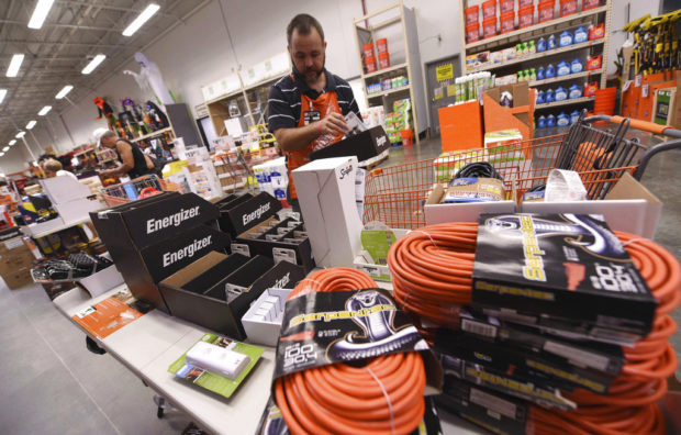 James Wemyss puts out more supplies at The Home Depot on Monday, Sept. 10, 2018, in Wilmington, N.C. Florence rapidly strengthened into a potentially catastrophic hurricane on Monday as it closed in on North and South Carolina, carrying winds and water that could wreak havoc over a wide stretch of the eastern United States later this week. (Ken Blevins/The Star-News via AP)