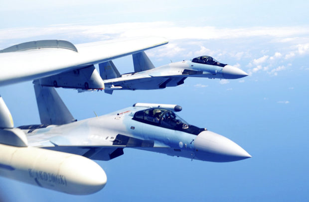 In this May 11, 2018, file photo released by Xinhua News Agency, two Su-35 fighter jets and a H-6K bomber from the People's Liberation Army air force fly in formation during patrol that included the Luzon Straits also known as Bashi Straits near Taiwan.  China has summoned the American ambassador and the defense attache and recalled its navy commander from a U.S. trip to deliver a strong protest against economic sanctions Washington lodged over the purchase of Russian fighter jets and surface-to-air missile equipment. The Defense Ministry says the U.S. had no right to interfere in Chinese military cooperation with Russia. The U.S. says the purchase of the weapons violates a law punishing Moscow for interfering in U.S. elections.  (Liu Rui/Xinhua via AP, File)