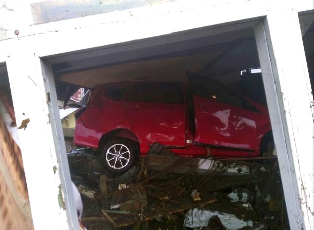 Red car swept by tsunami in Indonesia