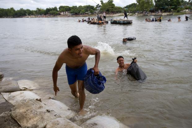 Central American migrants crossing Suchiate River