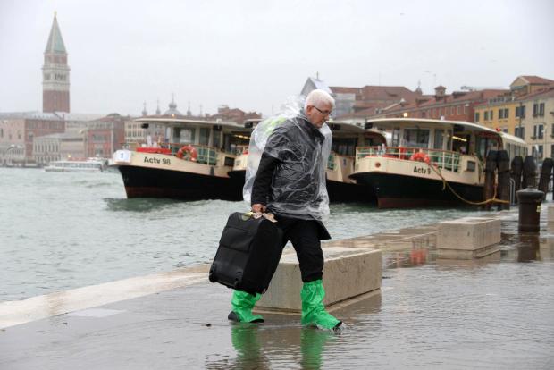 Man walks in flooded Venice