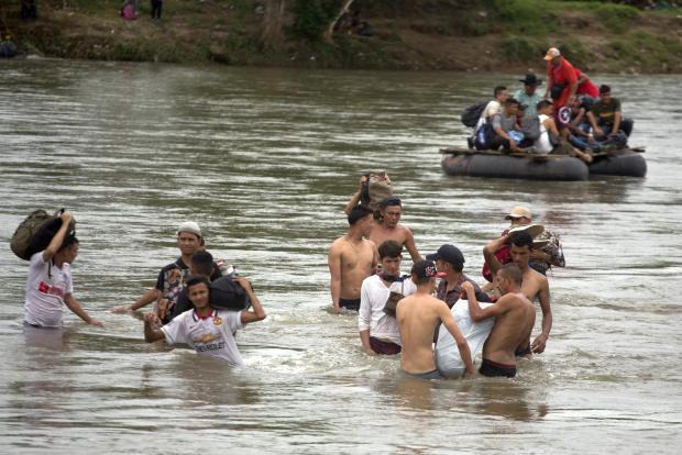 Migrants wading through Suchiate River