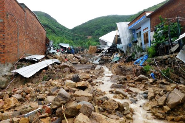 Damaged houses and debris are seen following flash floods and landslides in the Phuoc Dong commune of central Vietnam's Khanh Hoa province on November 18, 2018. - Flash floods and landslides killed at least 12 people in central Vietnam, officials said on November 18, as hundreds of troops were dispatched to clean up destroyed villages and washed out roads. (Photo by Hoang DUNG / AFP)