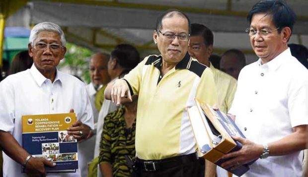 REHAB MASTER PLAN Then President Benigno Aquino III receives a copy of the master plan for the rehabilitation of areas hit by Supertyphoon “Yolanda” from Panfilo Lacson, eight months after appointing the former police chief presidential assistant for rehabilitation and recovery in December 2013. —INQUIRER FILE PHOTO