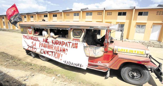 Members of the urban poor group Kadamay join a caravan to support families who occupied government housing units in Pandi town, Bulacan. —NIÑO JESUS ORBETA