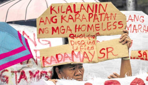 HOUSING WOES A woman joins a Kadamay protest rally at the National Housing Authority office in Quezon City to ask the government to solve the country's problems on housing.  —JAM STA. ROSA